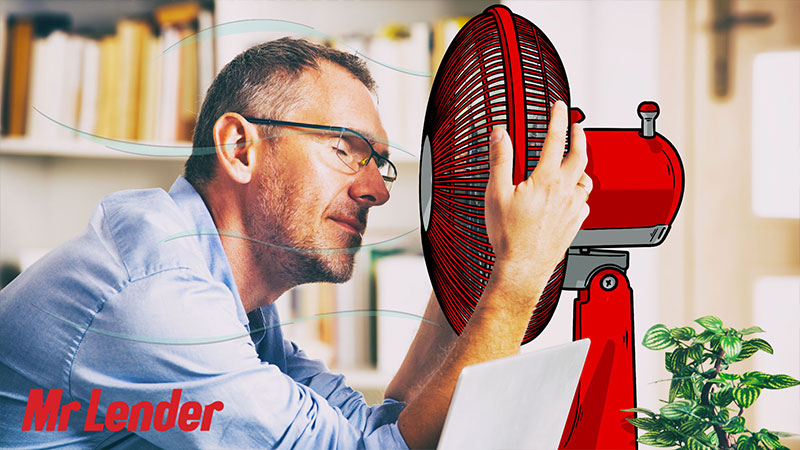 Man using a fan to cool down